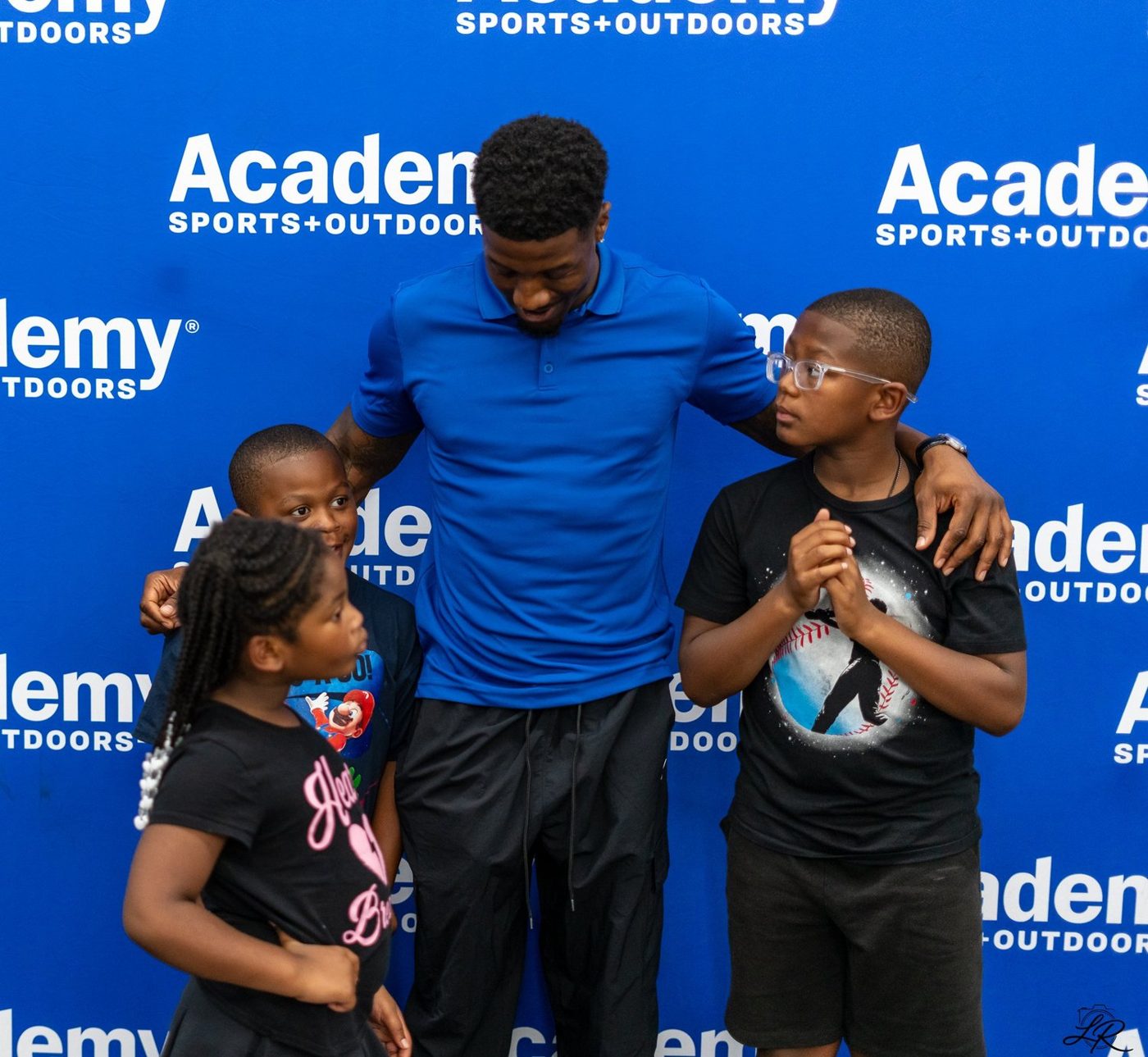 Anthony Miller II sharing a warm moment with a supporter at Academy Sports