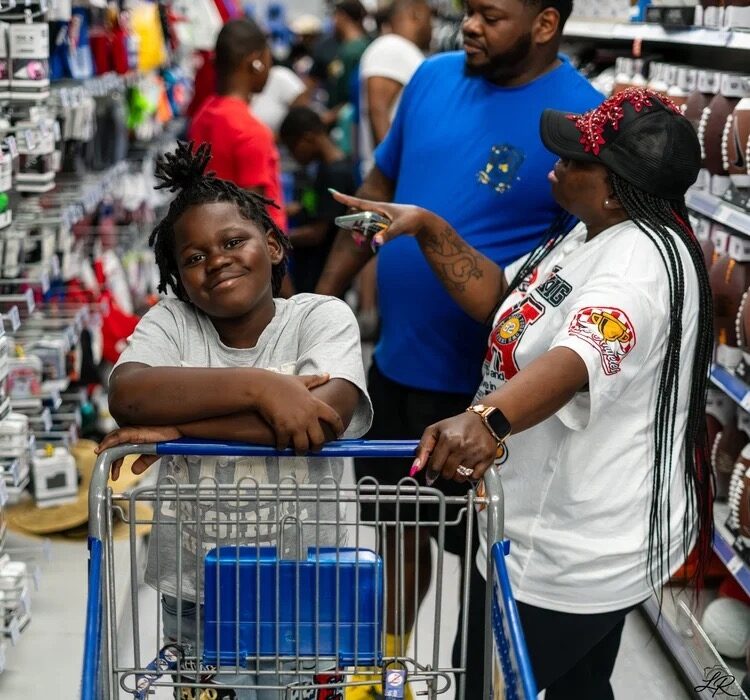A camper and family member at a back-to-school shopping giveaway