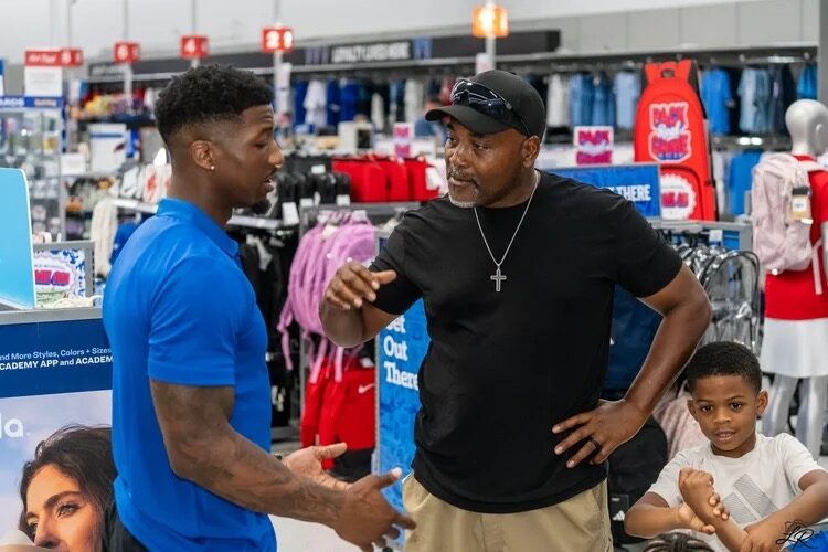 Anthony Miller II speaking with a mentor at a community event